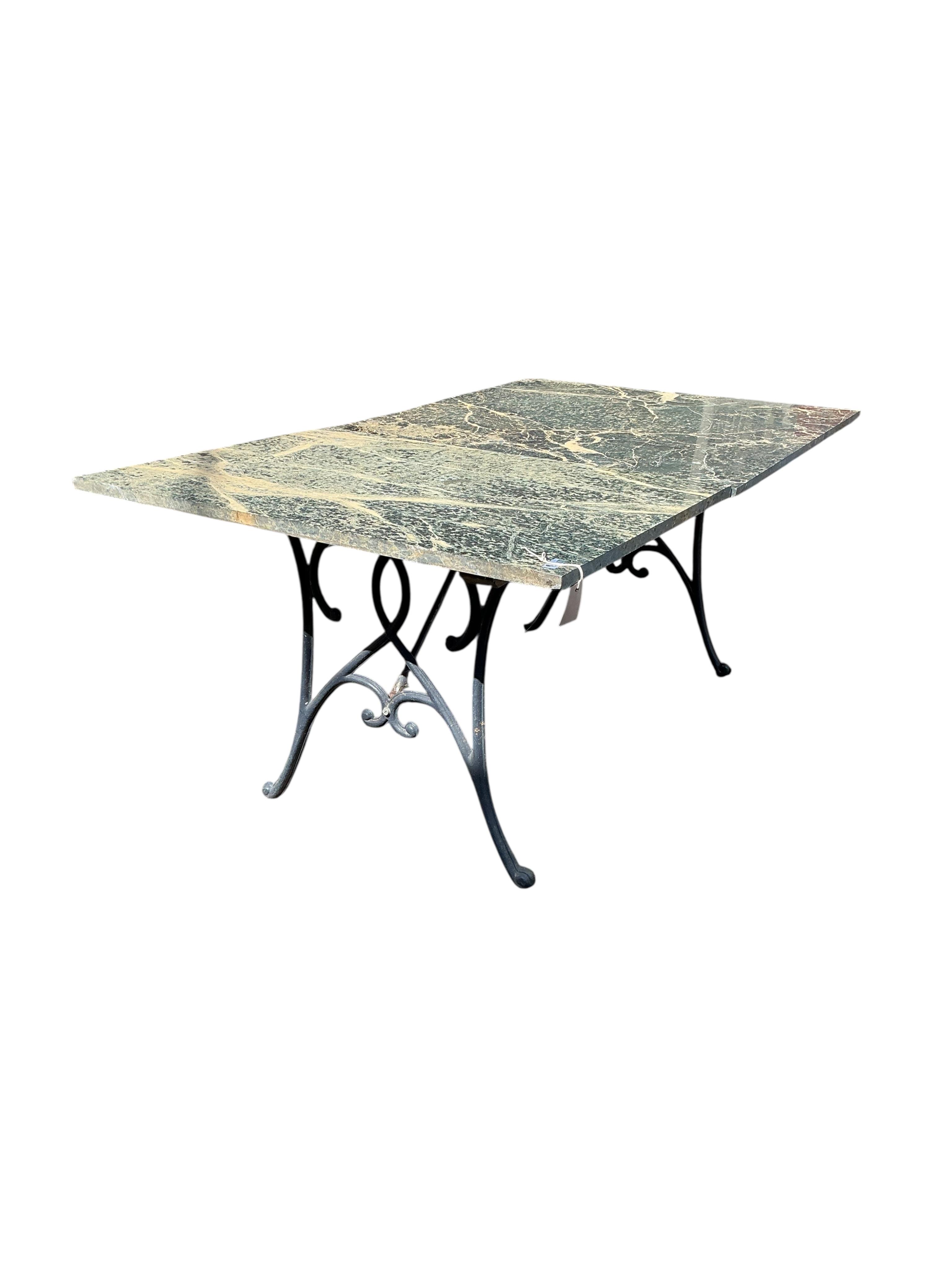 A rectangular reconstituted marble and cast metal garden table, marble in two sections, width 160cm, depth 94cm, height 66cm